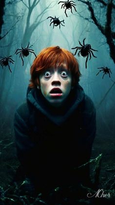 a boy with red hair and blue eyes is surrounded by spider's in the woods