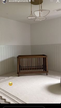 a baby crib sitting in the corner of a room with white walls and carpet