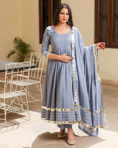 This 3 Pc anarkali Suit set is designed in mul-mul cotton fabric with Gota work mul-mul Dupatta. Kurta Length - 50, Mul-mul Cotton, Gota work With on hem & sleeves. Pant length - 38, Mul-mul cotton. Dupatta - Mul-mul cotton, gota work on edges. Fabric - mul-mul cotton. Color - Grey CARE: dry clean only. Shipping - 10-12 working days. DISCLAIMER - The color of the product may be differ from the image 10-12% due to camera and lights and screen settings of device. Grey Anarkali Suits, Cotton Anarkali Set With Zari Work For Wedding, Cotton Anarkali Set With Gota Work, Festive Cotton Churidar With Gota Work, Diwali Designer Cotton Sets, Cotton Anarkali Set With Zari Work, Designer Cotton Palazzo Set With Gota Work, Cotton Anarkali Set For Festive Occasions, Designer Cotton Anarkali Set With Dupatta