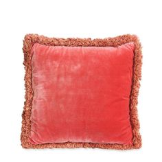 a red pillow with fringe edges on a white background