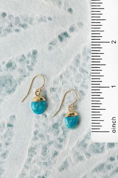 The Surrender Collection is soft and captivating. These simple turquoise earrings are finished with gold filled ear wires and are ideal for pairing with other items from the collection. Gold Filled (nickel and lead-safe) Turquoise 1", with gold filled ear wires We hand select our natural materials, thus there may be slight variations in color and/or size that will not detract from the overall aesthetic Our unique handcrafted designer jewelry for women is made in America, each design created indi Turquoise Dangle Jewelry With French Hook, Turquoise Brass Jewelry With Ear Wire, Turquoise Teardrop Brass Jewelry, Turquoise Earrings With Lever Back Ear Wires For Gifts, Turquoise Earrings With Lever Back Ear Wires As Gift, Turquoise Jewelry With French Hook For Gift, Turquoise 14k Gold Filled Earrings For Gift, Turquoise 14k Gold Filled Earrings As Gift, Gift Turquoise 14k Gold Filled Earrings