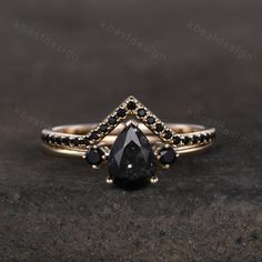 a black diamond ring on top of a rock