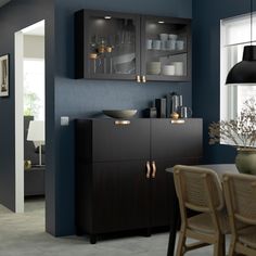 a dining room table and chairs in front of a wall mounted cabinet with glass doors