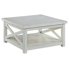 a white coffee table sitting on top of a wooden floor