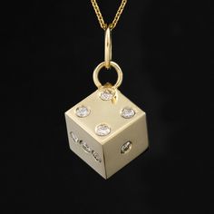 Why a dice, you ask? Well, we love die charms and pendants because they symbolize luck, chance, and risk-taking. Wearing dice-themed jewelry is often seen as a talisman or a way to attract good fortune and positive outcomes. This one has a nice, hefty feel to it, and with twinkling old cut diamonds all around! Perfect on both a charm bracelet or as a pendant. 14kt yellow gold Measures 1 cm 8.1 grams Diamonds are estimated to be G/H colors & VVS/SI1 clarities. GIA standards Please see qualitative Yellow Gold Jewelry With Diamond Markers For Gift, Gift Jewelry With Square Pendant And Single Cut Diamonds, Gift Jewelry With Single Cut Diamonds Square Pendant, Square Pendant Jewelry With Single Cut Diamonds For Gift, Luxury Diamond Charms For Gifts, Diamond Charms With Diamond Accents For Gifts, Symbolic Diamond Charms Jewelry, Luxury Square Pendant Jewelry With Charms, Luxury Good Luck Charms Necklaces