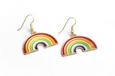 "These sweet rainbow earrings can't wait to spruce up your festival outfit with some serious retro-boho charm! Earring hooks are hypoallergenic. ▲ Rainbow charms measure approx. 1\" x 1 1/8\" ▲ Gold-plated surgical steel earring hooks (hypoallergenic) We try to display product colors as close to life as possible. However, all computer monitors are different and so there might be slight color variations from screen to screen. If you have any questions, feel free to contact us! CARE INSTRUCTIONS J Multicolor Dangle Earrings For Everyday, Everyday Multicolor Dangle Earrings, Multicolor Drop Earrings For Everyday, Multicolor Dangle Earrings, Nickel-free Multicolor Earrings For Everyday Use, Everyday Multicolor Nickel Free Earrings, Everyday Multicolor Nickel-free Earrings, Adjustable Rainbow Earrings As Gift, Fun Rainbow Earrings For Summer