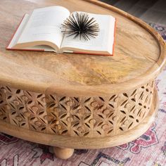 an open book sitting on top of a wooden table