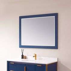 a bathroom vanity with a mirror above it and a blue cabinet under the sink in front of it