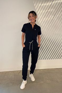 Empower Scrub Jumpsuit - Yitty Poses In Scrubs, Scrub Jacket Outfits, Scrubs Uniform Cute Aesthetic, Medical Receptionist Outfit Scrubs, Rbt Work Outfit Scrubs, Fall Scrubs Uniforms, Esthetician Scrubs Outfit, Black Scrubs Outfit Cute, Cna Outfits Scrubs