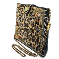 Experience the untamed beauty of this luxurious beaded handbag. This crossbody bag features a beaded animal print pattern enhanced with delicate beaded flowers and intricate jungle-inspired embroidery. The zipper and leather magnet closure with natural Prehnite gemstone will keep all your belongings safe and secure. The chain strap also features Prehnite gemstone accents and can be removed to carry as a clutch. 9.75 x 1 x 7.5" Strap Length End to End: 49" Strap Drop: 23" Removable crossbody chai Luxury Beaded Clutch Shoulder Bag, Luxury Handheld Beaded Shoulder Bag, Luxury Beaded Shoulder Bag, Luxury Beaded Bags For Everyday Use, Luxury Beaded Shoulder Bag For Fashion, Luxury Embellished Shoulder Bag, Elegant Embellished Shoulder Bag For Travel, Handmade Luxury Clutch For Travel, Elegant Embellished Travel Bags