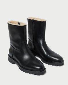 Mid-height boot in black vachetta leather. Features a shearling lining and a durable rubber lug sole. Pulls on. 1.5-inch heel. Mid Height Boots, Lug Sole Boots, 5 Inch Heels, Lug Sole, Black Cream, Black Boots, Black Leather, Sleek, Thing 1