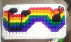 a close up of a cross stitch bag with sunglasses on the front and rainbow in the back