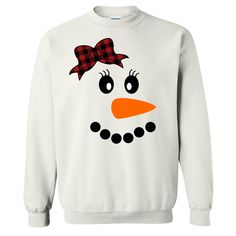 This Snowman With Buffalo Plaid Bow Tee is perfect for this holiday season and beyond. This festive design is a fun way to celebrate the winter season. With both youth and adult shirts available this is a super cute choice to pair with a pair of buffalo paid lounge pants for family Christmas lounge wear sets! This tee also pairs nicely with skinny jeans, vest, and booties for an adorable festive look.  GILDAN Short Sleeve - 6.0 oz. pre-shrunk 100% cotton Long Sleeve - 6.0 oz. pre-shrunk 100% cot Fun White Winter Tops, Fun Winter Crew Neck T-shirt, Fun White Tops For Winter, Fun Winter T-shirt With Crew Neck, Fun Crew Neck T-shirt For Winter, Fun White Christmas Tops, Playful Cotton Holiday Tops, Fun White Holiday Tops, Playful Cotton Tops For The Holiday Season