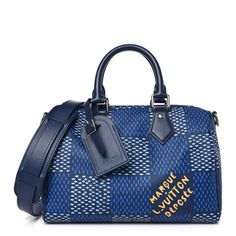 This is an authentic LOUIS VUITTON Damier Heritage Speedy Bandouliere 25 in Blue. This is crafted of new Damier Heritage coated canvas with blue leather trim. This bag features leather top handles and optional shoulder strap with silver hardware. The top zipper opens to a beige fabric interior with a patch pocket. Blue Rectangular Monogram Canvas Bag, Blue Monogram Canvas Shoulder Bag For Daily Use, Blue Luxury Monogram Canvas Shoulder Bag, Blue Monogram Canvas Top Handle Shoulder Bag, Blue Monogram Canvas Shoulder Bag With Top Handle, Designer Blue Satchel With Leather Handles, Designer Blue Bags With Leather Handles, Blue Monogram Canvas Bag With Detachable Handle, Blue Coated Canvas Satchel Bag