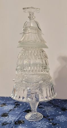 Just in time for your Holiday decorating. This one of a kind tree would be the perfect addition. It is made from upcycled glassware. The lights are NOT included, just used to help showcase the tree. But I did purchase them at Dollar Tree.  This tree measures approx. 17 1/2" x 9". It weighs about 6 pounds. Diy Glass Christmas Tree, Upcycled Glassware, Christmas Table Deco, Milk Glass Centerpiece, Glass Christmas Trees, Glass Totems, Unusual Christmas Trees, Crystal Trees, Glass Angels