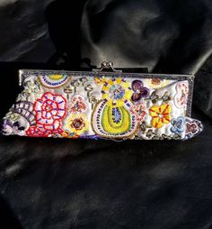 Fabulous embroidered purse! This bag was bought on one of my trips to Amsterdam. This clutch also has a silver 14" inch  chain that is detachable.  Inside little pocket. Bag measures 10" inches across, and 4" inches tall. Alot of handiwork on this bag, embroidery, sequins, rhinestones, metallic stitching, glass beads. Near the top of bag there is also 2 rows of little black iridescent seed beads.  This bag has Never been worn.  Thanks, Enjoy! #fashion #style #bohostyle #festival #dope #folk #tribe #gift #hippie #amazing #gorgeous #ethnic #tribal #fabulous #awesome #wedding #bride #bridal Handmade Bohemian Clutch For Spring, Handmade Bohemian Spring Clutch, Bohemian Rectangular Clutch For Spring, Spring Bohemian Rectangular Clutch, Bohemian Evening Rectangular Clutch, Bohemian Rectangular Spring Clutch, Bohemian Embroidered Pouch Evening Bag, Bohemian Embellished Pouch Evening Bag, Bohemian Embroidered Clutch Evening Bag