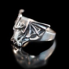 This solid sterling silver, Bat Flight Ring has a 1 1/4" wingspan. This unique ring lays flat along the finger making it comfortable and easy to wear. Take flight with one tonight!We have many ring sizes immediately available. We will contact you to let you know if we have your chosen ring size in stock or when to expect shipment.All Marty Magic Jewelry is packaged in a beautiful box embossed with the gold foil Marty Magic dragon logo. Perfect for any occasion!Designed in Santa Cruz California b Gothic Winged Jewelry For Gifts, Gothic Winged Jewelry Gift, Silver Winged Fantasy Jewelry, Silver Wing-shaped Fantasy Jewelry, Silver Fantasy Wing-shaped Jewelry, Fantasy Silver Wing-shaped Jewelry, Gothic Silver Ring With Polished Finish, Unique Hand Cast Rings For Halloween, Silver Gothic Rings With Polished Finish