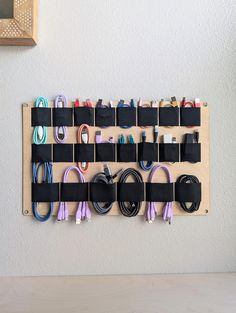 a wall mounted display with many different cords