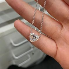 A heart-shaped diamond necklace, featuring a minimalist design, epitomizes elegance through its simplicity. The diamond delicately set without bezel takes center stage without distraction. The chains are available in different length ranging from 14 inches to 18 inches, available in 14K and 18K gold karats, and white, yellow, or rose color. You may also choose  your diamond size starting from 0.5 to 3 carats. Customize your necklace using the drop-down menus. This listing features a lab grown diamond. Lab grown diamonds have identical physical, chemical, and optical properties to mined diamonds, including hardness, brilliance, and fire, at a more affordable price point. Lab diamonds are also more environmental friendly and conflict-free. They are graded using the same 4C standards as mined Minimalist Heart Cut Diamond Jewelry, Minimalist Heart Pendant Diamond Necklace For Anniversary, Minimalist Heart Cut Cubic Zirconia Jewelry, Minimalist White Gold Heart-cut Jewelry, Minimalist Heart-shaped Diamond White Jewelry, Minimalist White Gold Heart Cut Jewelry, Minimalist Heart Cut White Gold Jewelry, Heart Shaped Solitaire Necklace Vvs Clarity, Diamond Heart Necklace With Clavicle Chain