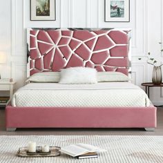 a pink bed with white sheets and pillows