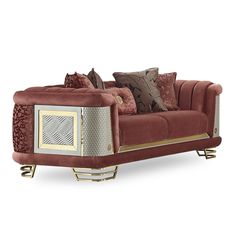 a red couch with pillows on it and some gold trim around the armrests