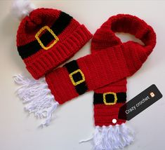 a knitted santa hat and scarf with a tag