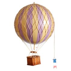 a purple and yellow hot air balloon with a basket hanging from it's side