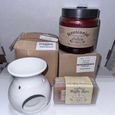 a table topped with boxes and jars filled with jam