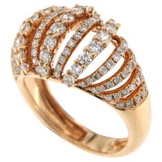 The ring in the image you've provided is a remarkable example of a diamond dome ring, featuring 1.64 carats of diamonds set in an 18K rose gold band. The design is characterized by its dome shape, which provides a generous canvas for the display of diamonds, allowing for a high degree of sparkle and visual impact. The diamonds are likely arranged in multiple rows that conform to the dome's curvature, offering a three-dimensional aspect that catches light from all angles. The rose gold's warm ton Gold Knot Ring, Chocolate Diamonds, Contemporary Ring, Dome Ring, Knot Ring, Rose Gold Band, Diamond Settings, Domed Ring, Antique Diamond