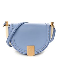 This is an authentic FENDI Vitello King Plexiglass Moonlight Shoulder Bag in Azzurro Sky. This stylish shopping tote is crafted of smooth leather in light blue with stitched detailing. It features ivory resin side detailing, a leather shoulder strap with gold hardware, and a gold Fendi embellishment on the front flap. The flap opens to reveal a brown suede leather interior with a patch pocket. Evening Blue Shoulder Bag With Leather Handles, Light Blue Leather Satchel Shoulder Bag, Light Blue Leather Shoulder Bag For Shopping, Light Blue Leather Shoulder Bag, Modern Light Blue Leather Shoulder Bag, Light Blue Leather Crossbody Shoulder Bag, Luxury Modern Light Blue Shoulder Bag, Luxury Blue Shoulder Bag With Leather Trim, Luxury Light Blue Tote Shoulder Bag