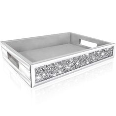 a white box with silver glitters on the bottom and sides, in front of a white background