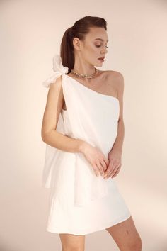 Short A-line dress made of linen, adjustable on one shoulder with the help of a silk bow and closes with a side-attached zipper.The model is 1.73 meters tall and is wearing size 36.FabricationMain: 100% LinenLining: 100% ViscoseBow: 100% SilkNon-sheer, Non-stretchCare GuideDry clean only Chic One-shoulder Linen Dress, One-shoulder Wedding Dress With Bow, Chic One-shoulder Summer Wedding Dress, Chic Summer Wedding One Shoulder Dress, Chic One Shoulder Summer Wedding Dress, Chic One-shoulder Dress With Bow And Asymmetrical Neckline, Chic One Shoulder Dress With Bow And Asymmetrical Neckline, Party Linen Tie Back Dress, Elegant Asymmetrical Linen Dress