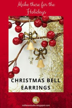 christmas bell earrings are hanging from a tree branch with red berries and gold bells