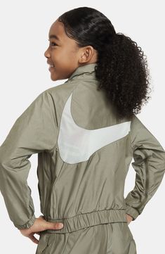 Breathable mesh and lightweight construction mean a comfortable fit in this kid-size jacket that'll keep young athletes warm on and off the playground. Front zip closure Stand collar Elastic cuffs Elastic waist Front welt pockets Lined 58% cotton, 40% polyester, 2% spandex with durable water-repellent (DWR) finish Machine wash, line dry Imported Nike Nylon Windbreaker For Sports, Nike Long Sleeve Outerwear For Light Sports, Nike Nylon Track Jacket For Athleisure, Nylon Moisture-wicking Track Jacket For Training, Breathable Nylon Sportswear Track Jacket, Sporty Long Sleeve Outerwear For Training, Nike Track Jacket For Spring Sports, Nike Long Sleeve Track Jacket For Light Sports, Nike Moisture-wicking Windbreaker For Sports