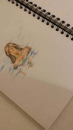 a drawing of a person's foot in the water on top of a notebook