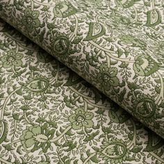 a green and white floral pattern on fabric