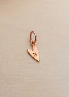 Add character and personalization to your jewelry with our Initial Heart Charm. Perfect for bracelets or necklaces, this charm adds a unique touch that reflects your individuality. Crafted with care and attention to detail, it's the perfect addition to any accessory collection. Size: 14mm x 7mm Available in gold plated over sterling silver, sterling silver, or rose gold plated over sterling silver. Heart-shaped Rose Gold Charm Jewelry, Anniversary Heart Charm Initial Pendant, Anniversary Heart Charm With Initial Pendant, Anniversary Heart Charm And Initial Pendant, Heart Charm Necklace For Friendship, Hand Stamped Heart Jewelry For Friendship, Personalized Small Charms For Gifts, Mother's Day Heart Charm Pendant, Heart Shaped Charm Necklaces For Friendship