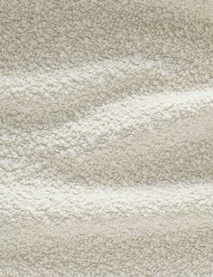 a close up view of a white rug