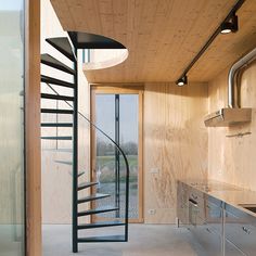 a spiral staircase in the middle of a kitchen