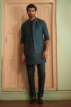 Teal blue silk bundi with sequins hand embroidery. - Aza Fashions Embellished Raw Silk Traditional Wear For Eid, Embroidered Silk Sherwani For Party, Embellished Chanderi Kurta For Transitional Season, Party Silk Sherwani With Embroidery, Transitional Embellished Chanderi Kurta, Embellished Blue Raw Silk Set, Blue Embellished Raw Silk Sets, Party Silk Embroidered Sherwani, Fitted Raw Silk Bandhgala With Intricate Embroidery