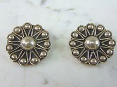 "A PAIR OF WOMENS VINTAGE ESTATE STERLING SILVER FLOWER CLIP ON EARRINGS. THE EARRINGS WEIGH 24.5g AND MEASURE 1 3/8\" IN DIAMETER. ANY QUESTIONS PLEASE DO NOT HESITATE TO ASK. BE SURE TO CHECK OUT SOME OF OUR OTHER GREAT PIECES OF JEWELRY FOR SALE. THANK YOU. IF THERE ARE ANY ISSUES PLEASE CONTACT US, WE'RE ALWAYS HAPPY TO TRY TO HELP YOU OUT AS BEST AS WE CAN." Vintage Flower-shaped Earrings For Anniversary, Vintage Flower-shaped Pierced Earrings, Vintage Flower Shaped Earrings, Vintage Flower Shaped Clip-on Earrings, Vintage Silver Flower-shaped Earrings, Vintage Flower Shaped Earrings For Anniversary, Vintage Flower Earrings For Anniversary, Vintage Silver Pierced Flower Earrings, Vintage Silver Flower Earrings Pierced