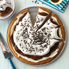 there is a pie with white frosting and chocolate sprinkles on it