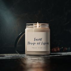 a candle that is sitting on top of a table with the words saint, whose of whom pray for us