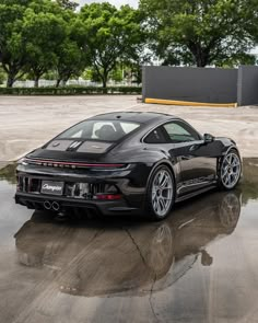 a black sports car parked in a parking lot