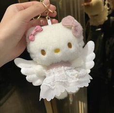 a hello kitty keychain with angel wings