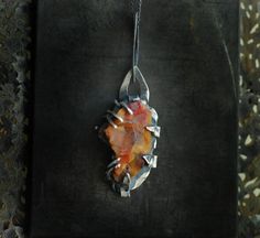 'Flame' is hand sculpted of sterling silver, fine silver, and a natural surface petrified wood. With this piece, I have captured that ever elusive, shifting form of a raw flame and made it wearable. Nothing is hidden away on this piece. The flare of the raw edges, the shifting textures and colors, the raw beauty of the silver....all of it coalesces together to create an eternal flame. What that flame means to you is your choice. Perhaps it's a reminder to keep fighting, to keep striving, to keep Rainbow Wood, Red Pendant, Eternal Flame, Red Pendants, Raw Beauty, Wood Necklace, Wood Jewelry, Petrified Wood, Wood Jewellery