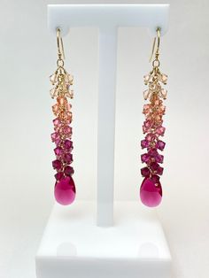 Elegantly designed handcrafted earrings made with authentic, 4mm light pinks to ruby Swarovski Crystals, finished with a ruby Swarovski pendant. *14k Gold Filled   Length: 3-inch drop Width: 10-12mm Storage bag and polishing cloth included. Fine Jewelry Pink Briolette Earrings, Pink Briolette Fine Jewelry Earrings, Elegant Pink Faceted Earrings, Pink Briolette Earrings For Gift, Pink Briolette Earrings As Gift, Pink Sterling Silver Briolette Earrings, Fine Jewelry Pink Briolette Jewelry, Pink Faceted Earrings For Jewelry Making, Pink Faceted Drop Earrings