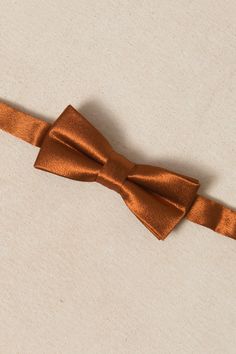 Get your littlest man looking dapper with the Baby Boys Henry Bow Tie in Amber Satin! Made from luxurious satin fabric and featuring a pre-tied bow, this bow tie is not only stylish but also convenient and comfortable. Plus, the adjustable neck strap ensures a proper fit for your little boy. Perfect for fall weddings, church, special events and more. Standard Tie Satin Bow, Adjustable Satin Bow Tie For Parties, Adjustable Satin Bow For Party, Classic Adjustable Satin Bow Tie, Classic Adjustable Satin Ties, Satin Bow Tie Back Ties For Party, Satin Party Ties With Bow Tie Back, Satin Ties With Bow Tie Back For Party, Satin Bow With Bow Tie Back For Gifts