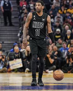 a basketball player standing on top of a court with a ball in front of him