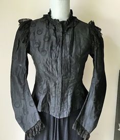 "Victorian Waist, Jacket, Black Figured Cotton Mourning Jacket Gorgeous antique Victorian waist jacket with self gathered collar,Princess seams going into a nice nice V  front and back, leg of mutton sleeves trimmed with black gathered lace and black gathered lace over the shoulders and around the back.  The inside seams are sewn by hand and it would of had three pieces of boning at one time . This would look great worn with jeans, slacks or a skirt. MEASURES: Bust - 34\"  Waist - 32\"  shoulder Leg Of Mutton Sleeve, Black Figure, Waist Jacket, 1980s Dresses, Victorian Clothing, Victorian Women, Black Gown, Sleek Fashion, Historical Clothing